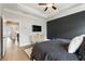 This primary bedroom features a dark accent wall and hard wood floors at 884 Mayfield Rd, Milton, GA 30009