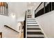 Stylish staircase with black treads and white risers, leading to the upper level at 884 Mayfield Rd, Milton, GA 30009