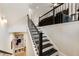 Modern staircase with black and white risers and dark stained railing at 884 Mayfield Rd, Milton, GA 30009