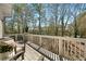 Exterior view of a wooden back deck with railings, outdoor seating, and wooded backyard at 2468 Skyland Ne Dr # 32, Atlanta, GA 30319