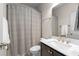 This bathroom has a shower with patterned curtain, toilet, and vanity with white counter at 2468 Skyland Ne Dr # 32, Atlanta, GA 30319