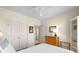 This bedroom has a queen bed with neutral colored walls, a ceiling fan, and white closets at 2468 Skyland Ne Dr # 32, Atlanta, GA 30319