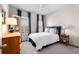 This bedroom has a queen bed with blue headboard, neutral colored walls and carpet, and a window at 2468 Skyland Ne Dr # 32, Atlanta, GA 30319