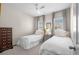 This bedroom has two twin beds, neutral colored walls and carpet, and a ceiling fan at 2468 Skyland Ne Dr # 32, Atlanta, GA 30319