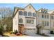 Charming two-story townhome with brick facade, gray shutters, and attached two-car garage at 2468 Skyland Ne Dr # 32, Atlanta, GA 30319