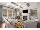 Cozy living room featuring built-in bookshelves, a fireplace, and ample natural light at 2468 Skyland Ne Dr # 32, Atlanta, GA 30319