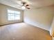 Neutral bedroom with a ceiling fan, and a window for natural light at 2921 Royston Dr, Duluth, GA 30097