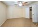Neutral bedroom with ceiling fan and an adjacent walk-in closet space at 2921 Royston Dr, Duluth, GA 30097