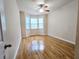 Bright bedroom featuring a ceiling fan, wood floors, and a bay window for natural light at 2921 Royston Dr, Duluth, GA 30097