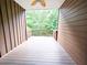 Outdoor deck with wood siding, offering a view of the surrounding trees at 2921 Royston Dr, Duluth, GA 30097
