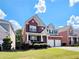 Charming two-story red brick home with a well-manicured lawn and a two-car garage at 2921 Royston Dr, Duluth, GA 30097