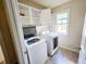Laundry area with a newer washer and dryer, plus storage cabinets at 2921 Royston Dr, Duluth, GA 30097