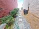A narrow side yard walkway and garden features stepping stones, bushes, and a water tap at 2921 Royston Dr, Duluth, GA 30097
