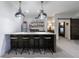 Basement bar with a refrigerator, dark cabinetry, pendant lighting, and a view to bedroom at 3680 Sewell Mill Rd, Marietta, GA 30062