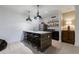Basement bar featuring a refrigerator, dark cabinetry, and pendant lighting at 3680 Sewell Mill Rd, Marietta, GA 30062