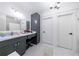 Bathroom featuring a marble countertop, vanity, and decorative mirror at 3680 Sewell Mill Rd, Marietta, GA 30062