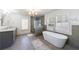 Elegant bathroom featuring a soaking tub, glass shower, double vanity, and bright natural light at 3680 Sewell Mill Rd, Marietta, GA 30062
