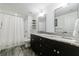 Modern bathroom with double sink vanity, walk in shower, and tiled floors at 3680 Sewell Mill Rd, Marietta, GA 30062