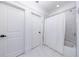 Bright bathroom featuring white tiled flooring and a tub shower at 3680 Sewell Mill Rd, Marietta, GA 30062