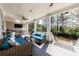 Charming covered porch with outdoor seating, a built-in workspace, and views of the lush green surroundings at 3680 Sewell Mill Rd, Marietta, GA 30062