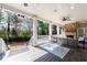 Inviting covered porch with a stone fireplace, comfortable seating, and a tranquil view of the surrounding landscape at 3680 Sewell Mill Rd, Marietta, GA 30062