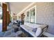 Spacious covered porch with outdoor furniture and rustic wood columns at 3680 Sewell Mill Rd, Marietta, GA 30062