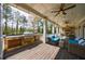 Expansive covered porch featuring an outdoor grill, cooking area, seating, and lovely backyard views at 3680 Sewell Mill Rd, Marietta, GA 30062