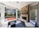 Relaxing covered porch featuring stone fireplace, comfortable seating, and stylish decor for outdoor enjoyment at 3680 Sewell Mill Rd, Marietta, GA 30062