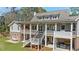 Rear exterior view of multi-tiered patio and porch areas with stairs leading to backyard at 3680 Sewell Mill Rd, Marietta, GA 30062