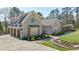 Beautiful two-story home with a three car garage, stone accents, and well manicured landscaping at 3680 Sewell Mill Rd, Marietta, GA 30062
