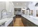 Contemporary kitchen with a farmhouse sink, granite countertops, stainless steel appliances, and ample cabinet space at 3680 Sewell Mill Rd, Marietta, GA 30062