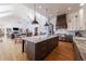 Open-concept kitchen and living area with large island, modern lighting, and stainless steel appliances at 3680 Sewell Mill Rd, Marietta, GA 30062