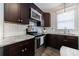 Modern kitchen features dark cabinets, stainless steel appliances, granite countertops and white subway tile at 3680 Sewell Mill Rd, Marietta, GA 30062