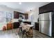 Kitchen features stainless steel appliances, dark cabinets, and natural light from the window at 3680 Sewell Mill Rd, Marietta, GA 30062
