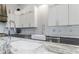 Close-up view of the kitchen featuring granite countertops, a farmhouse sink, and stainless steel appliances at 3680 Sewell Mill Rd, Marietta, GA 30062