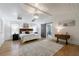 Spacious main bedroom featuring a tray ceiling, wood floors, natural light, and ensuite bathroom access at 3680 Sewell Mill Rd, Marietta, GA 30062