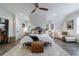 Bright main bedroom features wood floors, a decorative ceiling fan and lots of natural light at 3680 Sewell Mill Rd, Marietta, GA 30062