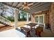Charming patio with ceiling fan, string lights, and access to backyard and living space at 3680 Sewell Mill Rd, Marietta, GA 30062