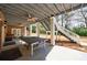 Outdoor patio features ping pong table, exposed beams, and multiple seating areas at 3680 Sewell Mill Rd, Marietta, GA 30062