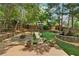 Well-maintained backyard featuring a stone water fountain, a fire pit, and a small retaining wall at 518 Hill St Se, Atlanta, GA 30312