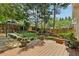 Serene backyard featuring a wooden deck, stone fountain, and lush landscaping, creating a private outdoor oasis at 518 Hill St Se, Atlanta, GA 30312