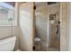 Contemporary bathroom showcasing glass-enclosed shower and tiled walls with natural light through the window at 518 Hill St Se, Atlanta, GA 30312