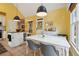 Bright dining area with a white table, gray chairs, and modern pendant lighting, located off of the kitchen at 518 Hill St Se, Atlanta, GA 30312