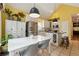Bright dining area with stainless steel refrigerator and white cabinets with wine rack, and modern pendant lighting at 518 Hill St Se, Atlanta, GA 30312