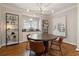 Charming dining room boasts hardwood floors, a round table with seating, shelving, and striking panda artwork on the wall at 518 Hill St Se, Atlanta, GA 30312