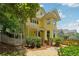 Beautiful two-story yellow home with a welcoming front porch and well-maintained landscaping at 518 Hill St Se, Atlanta, GA 30312
