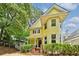 Charming yellow two-story home with a welcoming front porch and beautifully landscaped front yard at 518 Hill St Se, Atlanta, GA 30312