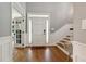 Inviting foyer with hardwood floors, stairs and paneled walls leading to a living area with glass paned doors at 518 Hill St Se, Atlanta, GA 30312