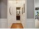 Hallway with wainscoting leading to a bathroom featuring a chandelier and decorative wallpaper at 518 Hill St Se, Atlanta, GA 30312
