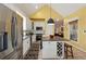 Kitchen area featuring stainless steel appliances, granite island with seating, and wine storage. Vaulted ceilings at 518 Hill St Se, Atlanta, GA 30312